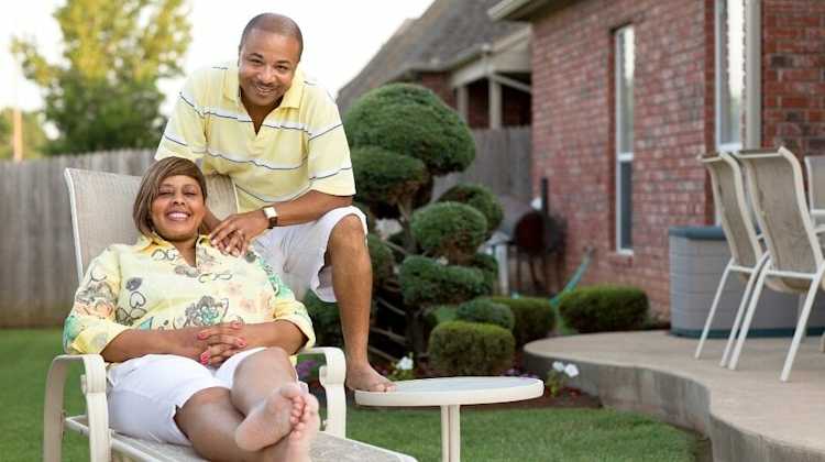 Couple relaxing in backyard