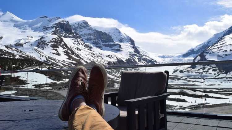 veteran relaxing on deck with view of snow-covered mountains