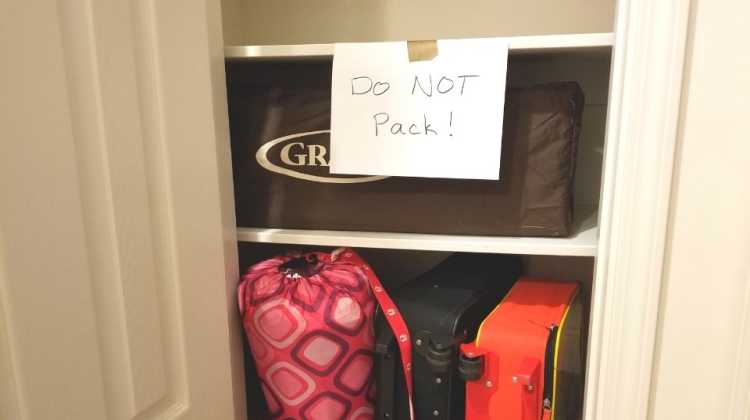 closet packed for PCS move with "Do Not Pack" sign for military movers