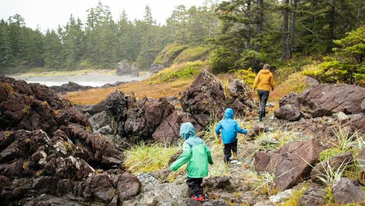 Military family and kids hike in rain gear in the Pacific Northwest, on a daytrip from JBLM