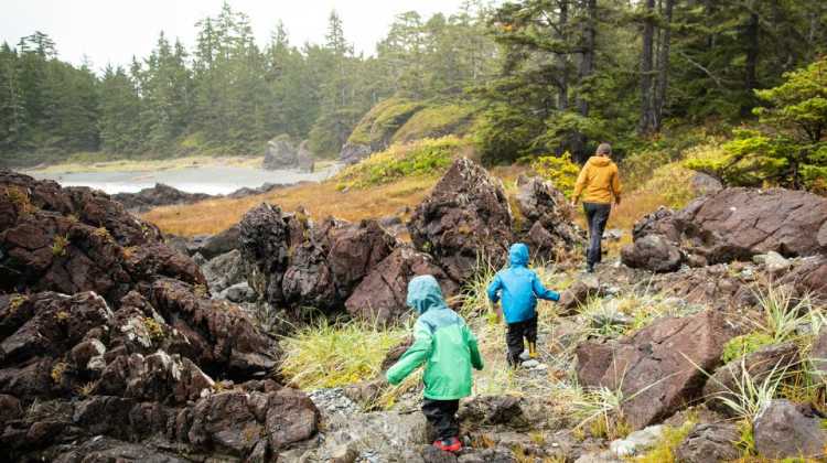 Military family and kids hike in rain gear in the Pacific Northwest, on a daytrip from JBLM