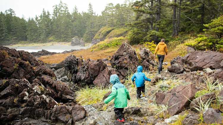 Military family and kids hike in rain gear in the Pacific Northwest, on a daytrip from JBLM