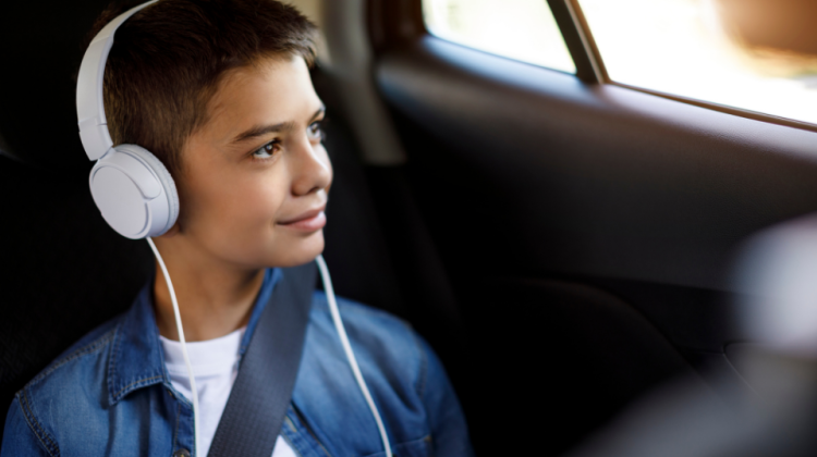 kid with headphones traveling