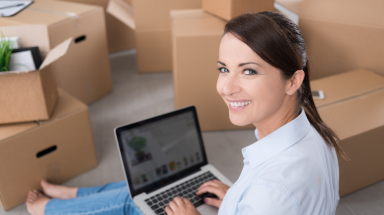 woman on laptop in front of boxes