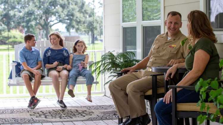 military family talking on porch