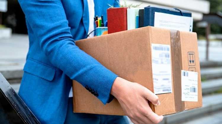 Binders and office supplies being moved