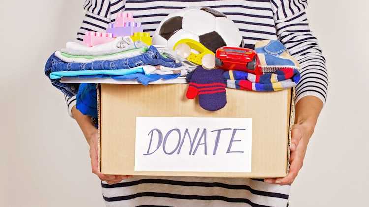 person holding full donation box