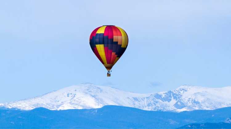 Hot air balloon floating over the Rocky Mountains, one of 10 amazing things to do in Colorado Springs