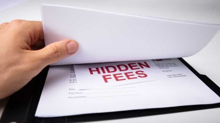 pile of contract paperwork showing hidden fees in mortgage loans