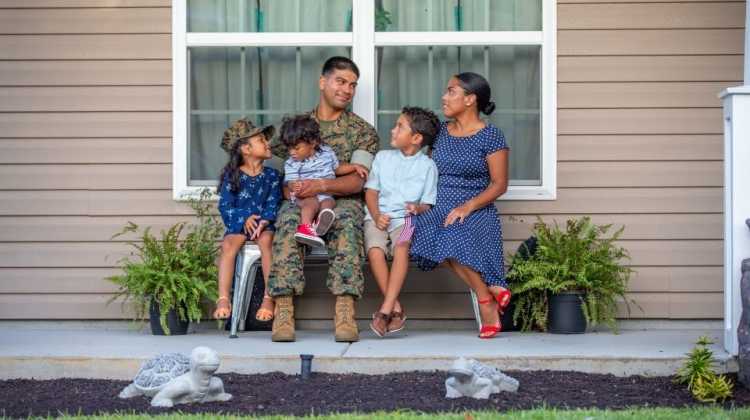 military family sitting on a bench
