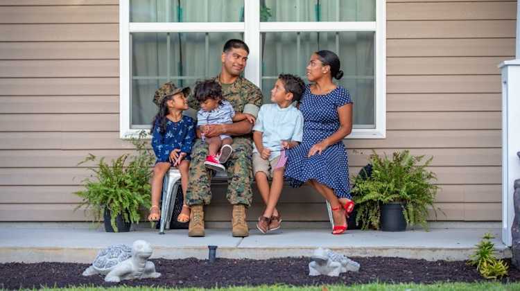 military family sitting on a bench