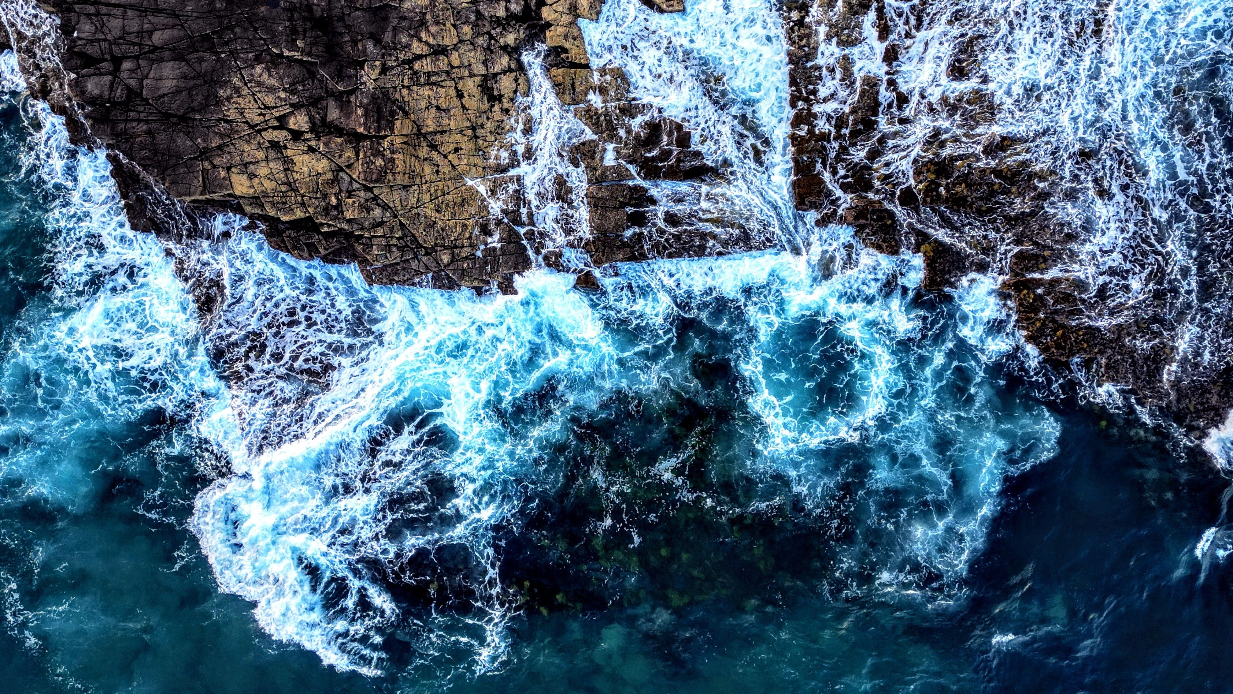 Waves crashing on ocean rocks
