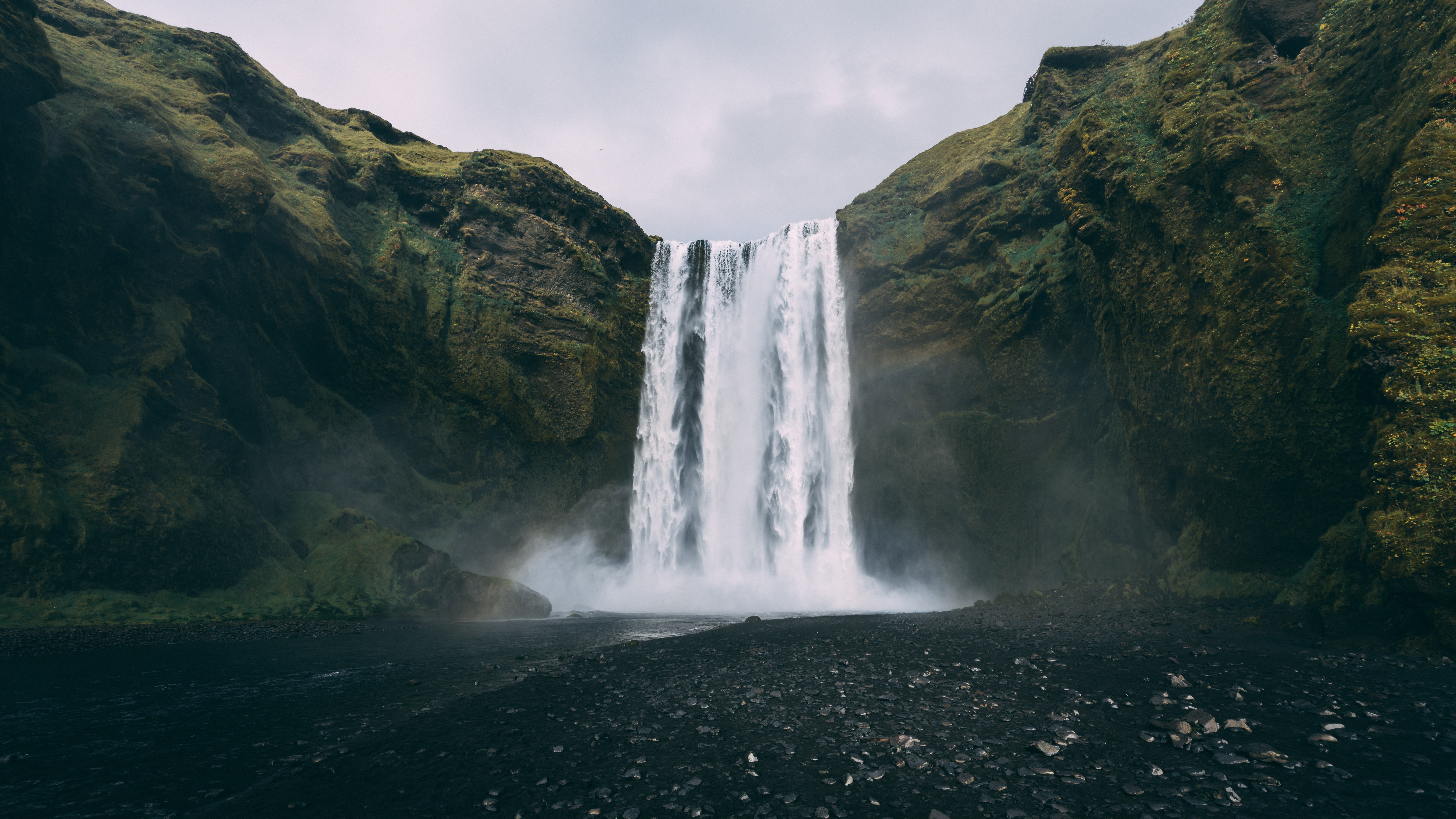 Waterfall coming down over mountains