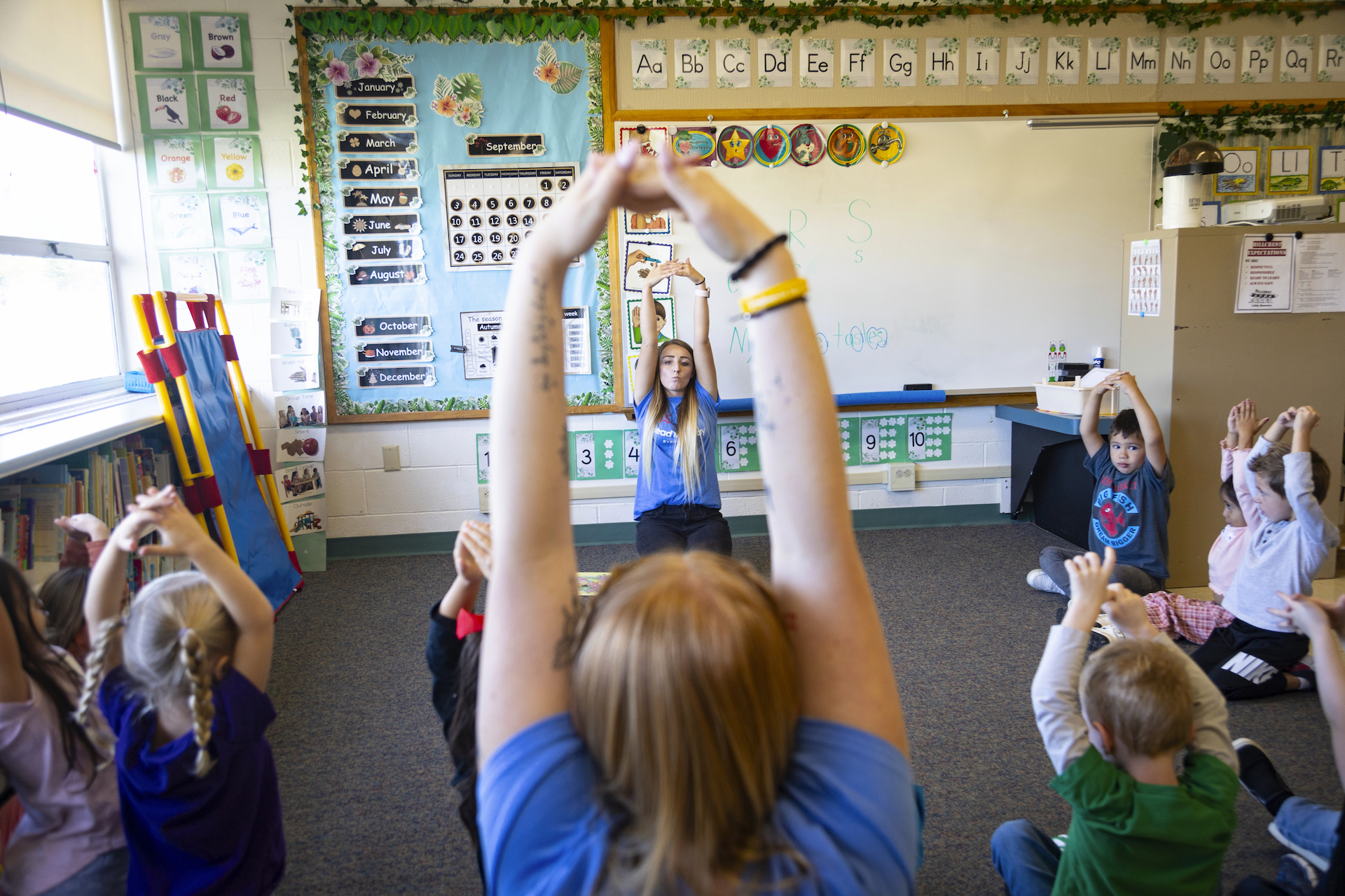 Hawker leads children in a breathing exercise, the kind of lesson designed to help them manage emotions. Photo by Kyle Green for The Associated Press.