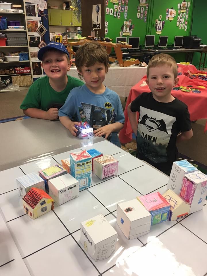 Students in the library, creating a city with robots
