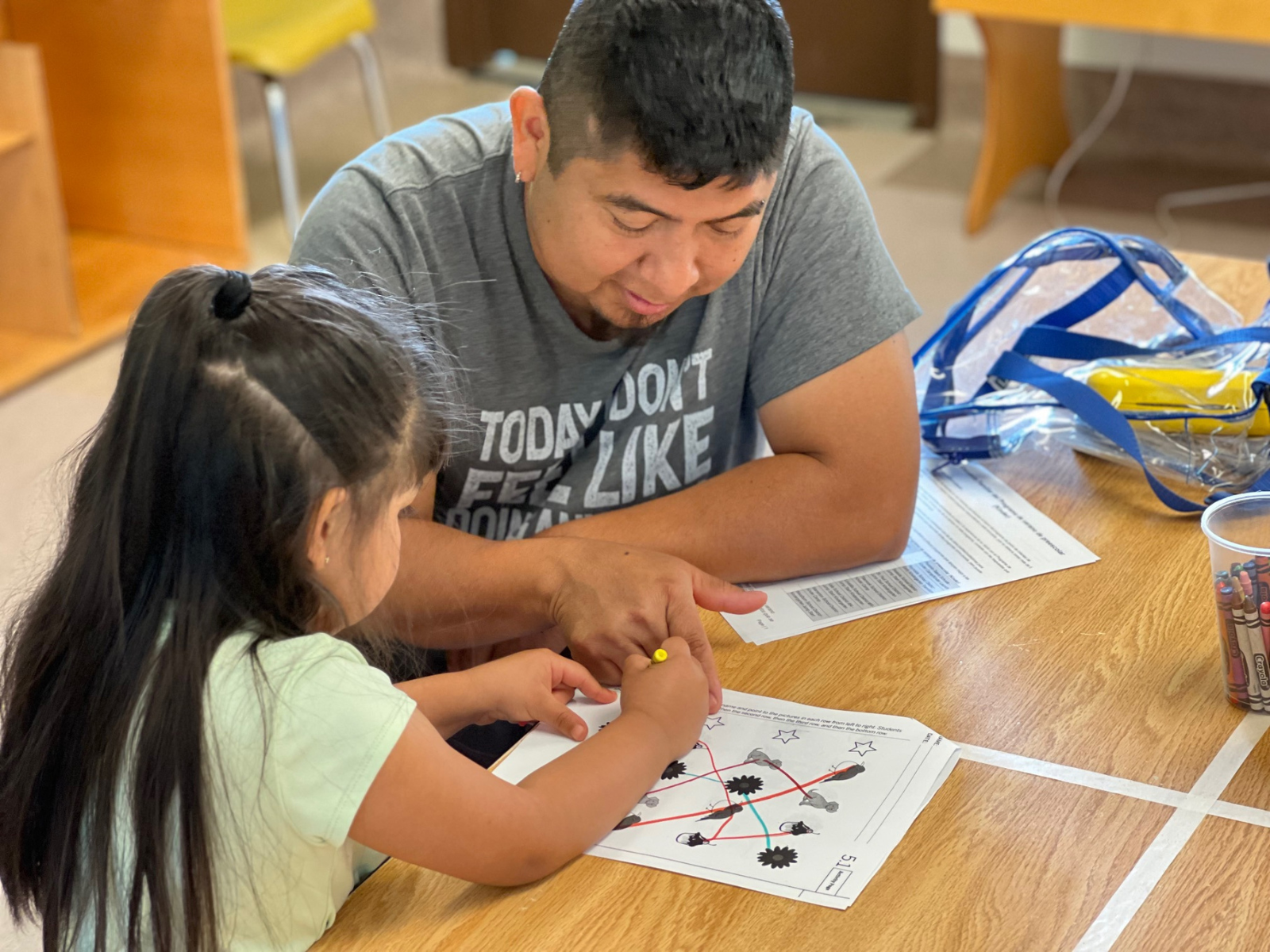 A teacher guides an incoming kindergartener through a matching activity during a Jump Start Kindergarten lesson. (Photo courtesy of Phoenix-Talent School District.)