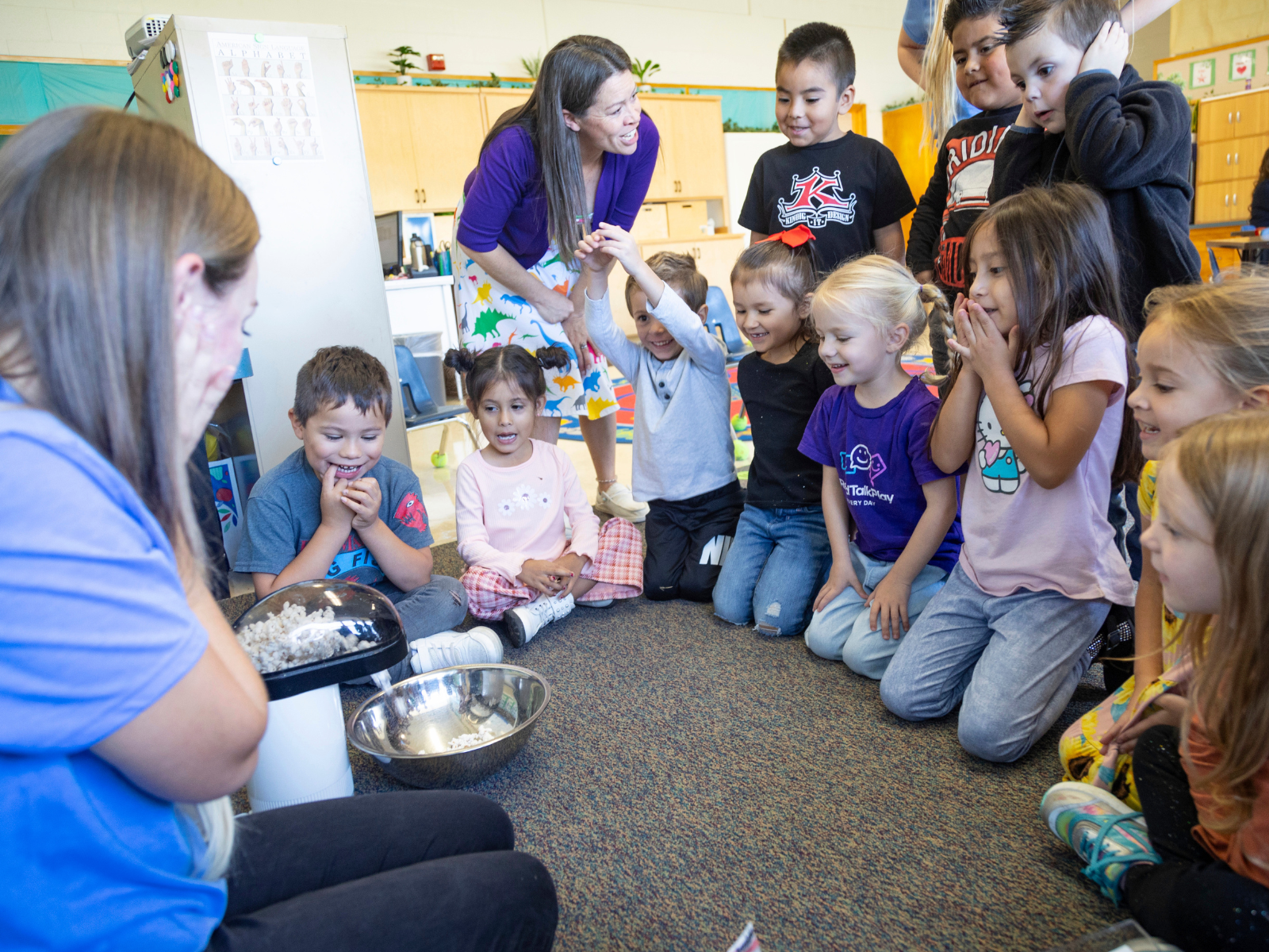 Hillcrest teacher Abi Hawker, left, leads preschoolers in a sensory-based learning activity involving popcorn on Thursday, Sept. 28, 2023. Photo by Kyle Green for The Associated Press.
