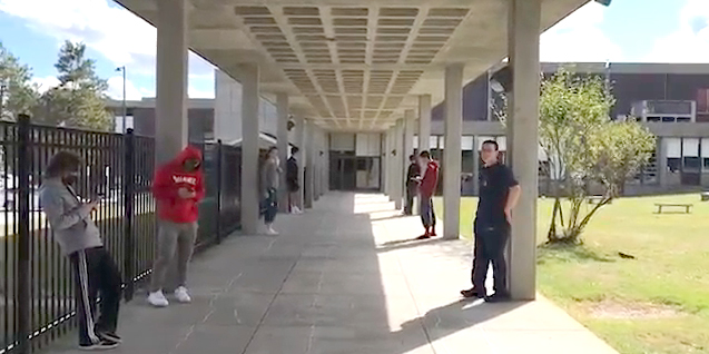 Students at Milford High School take a mask break outside while maintaining physical distance. Photo from a video provided by Christine Ravesi-Weinstein.
