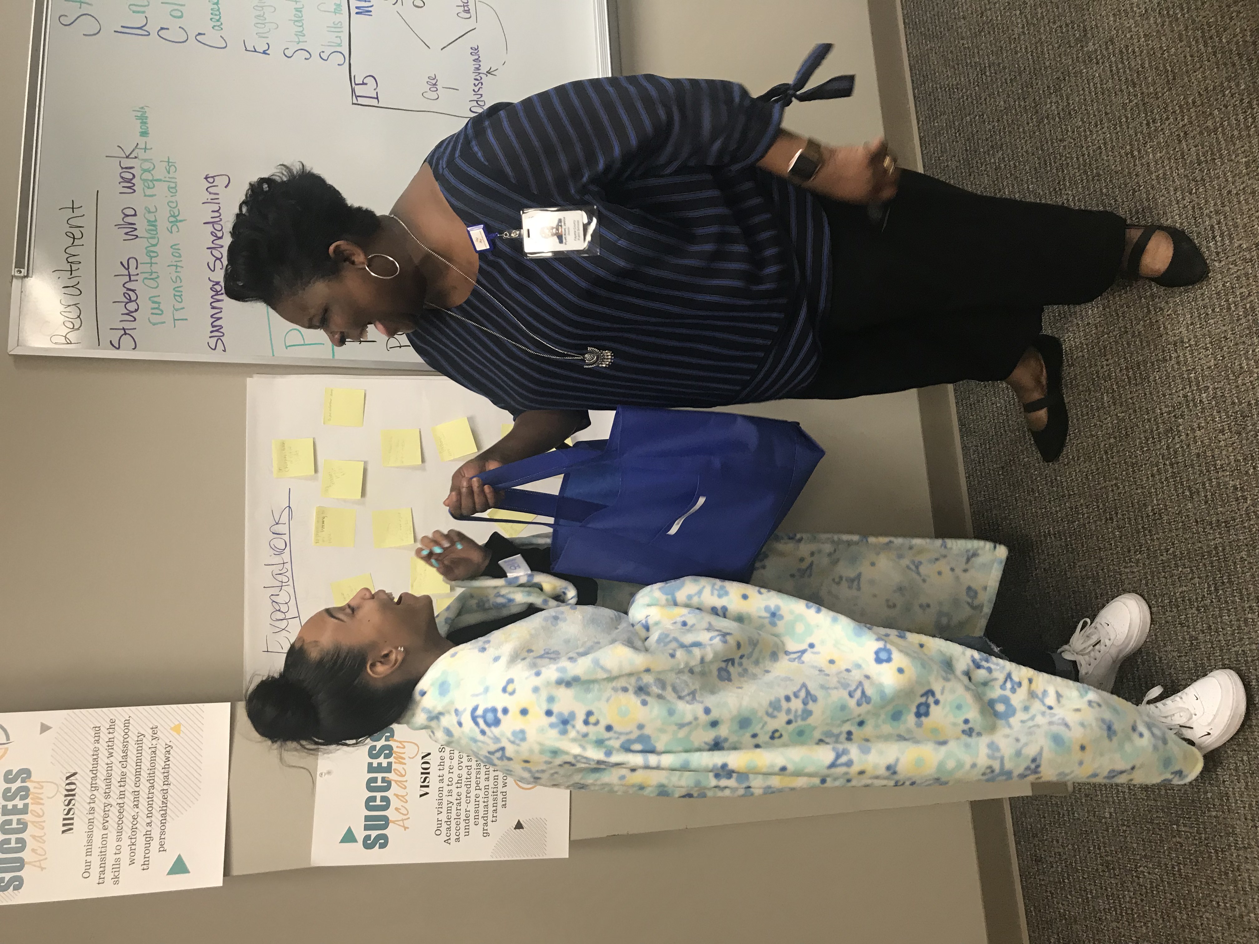 Dr. Ross giving a student a “goody bag” of essentials. (Credit: NyRee Clayton-Taylor)