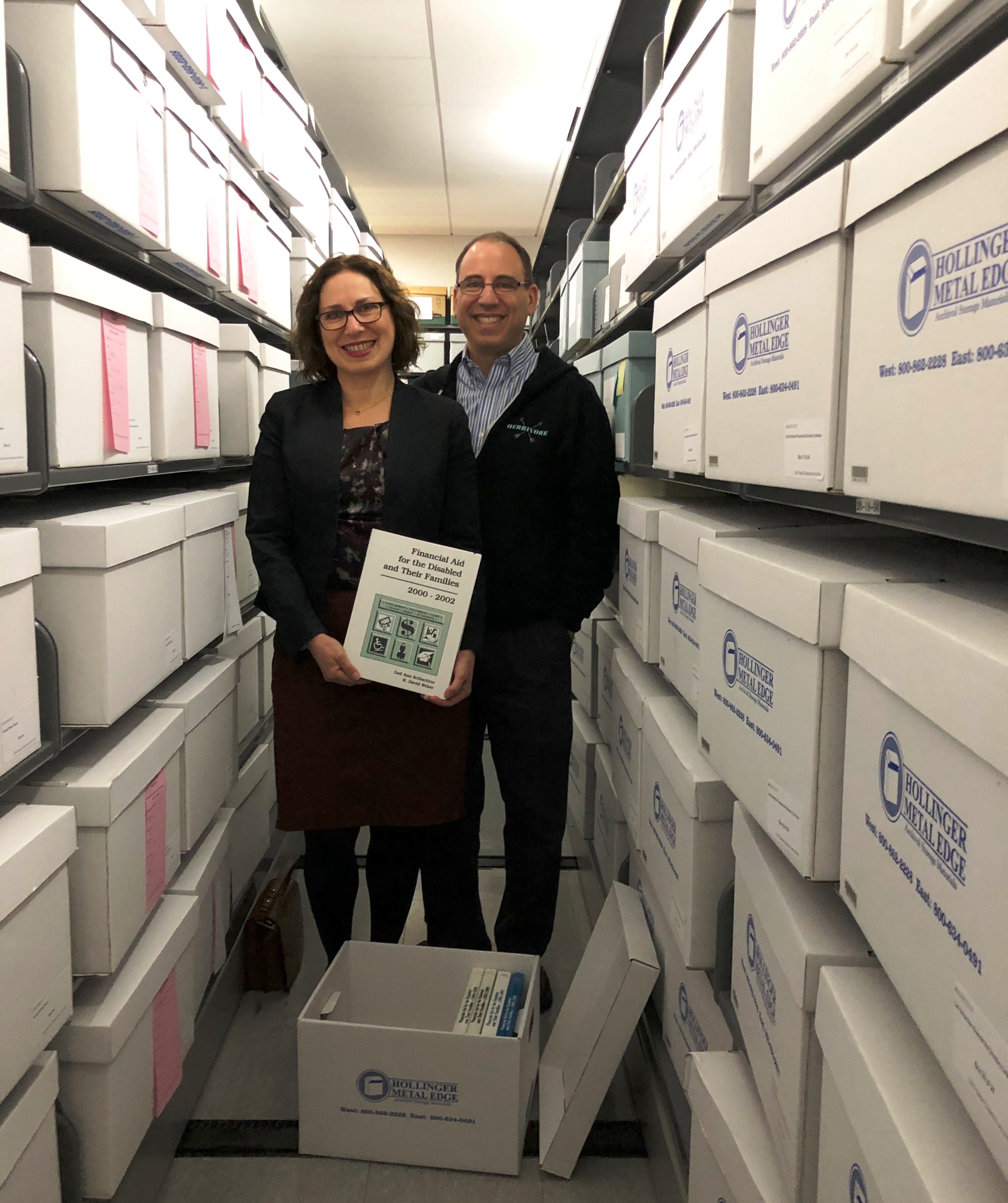 Sandy Hirsh and Eric Goldman in the archives with a Reference Service Press book.