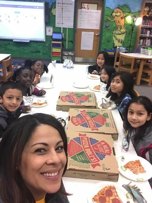 Students enjoy a celebratory pizza party