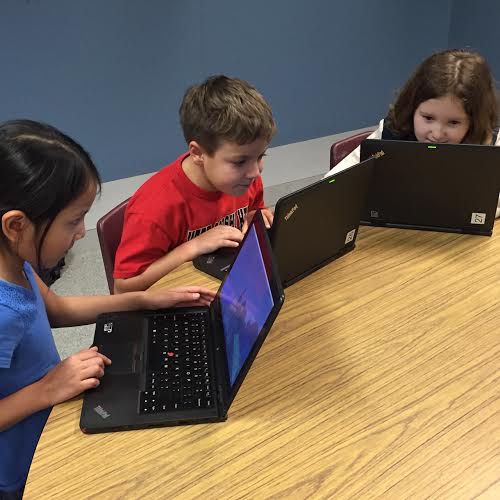 Duncan's second graders Natasha, Brett, and Delayna engage in "Morning Craft."