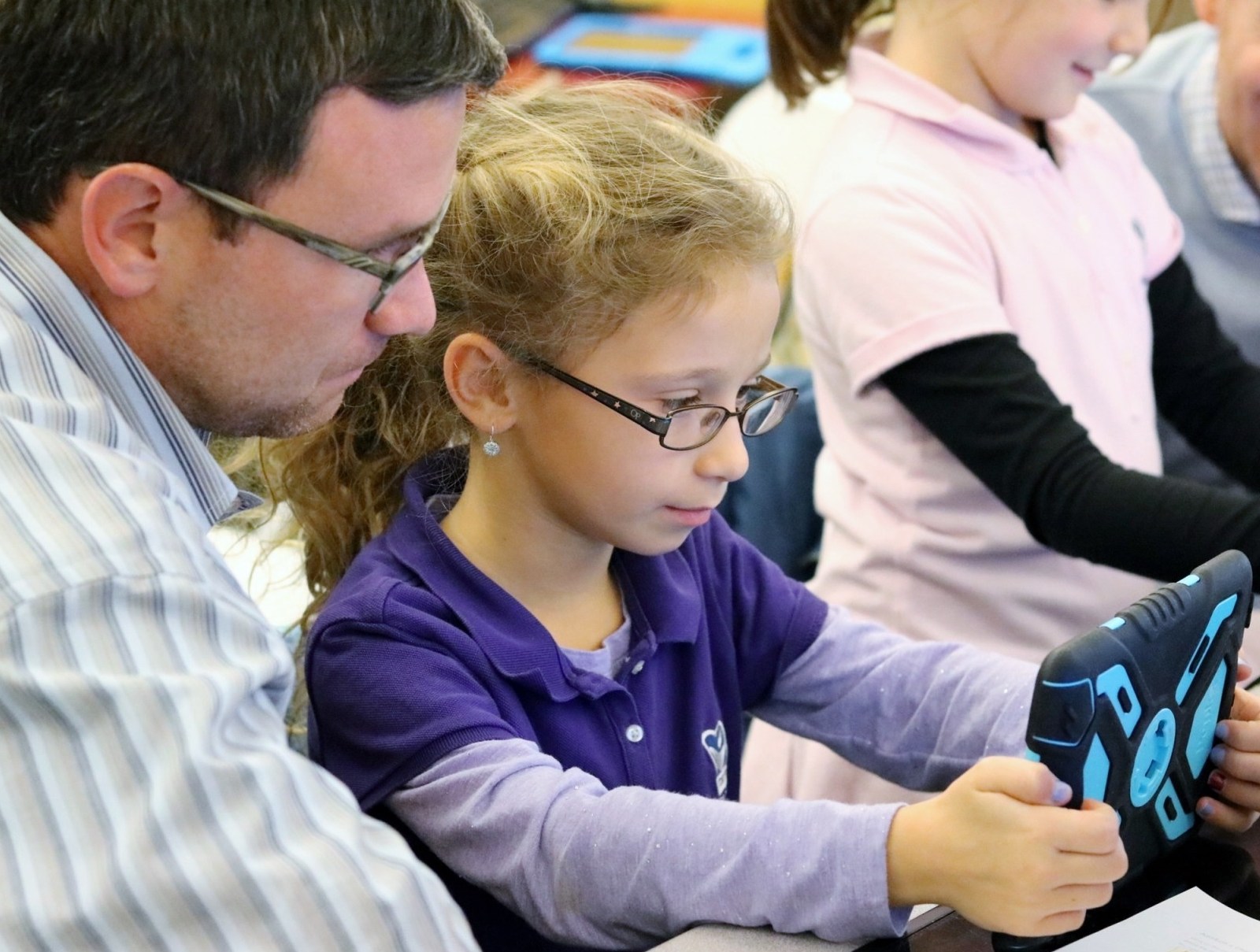 Tanya, age 7, and her father Albert work collaboratively on an open-ended coding project using the free ScratchJr programming application. Credit: Tufts University.