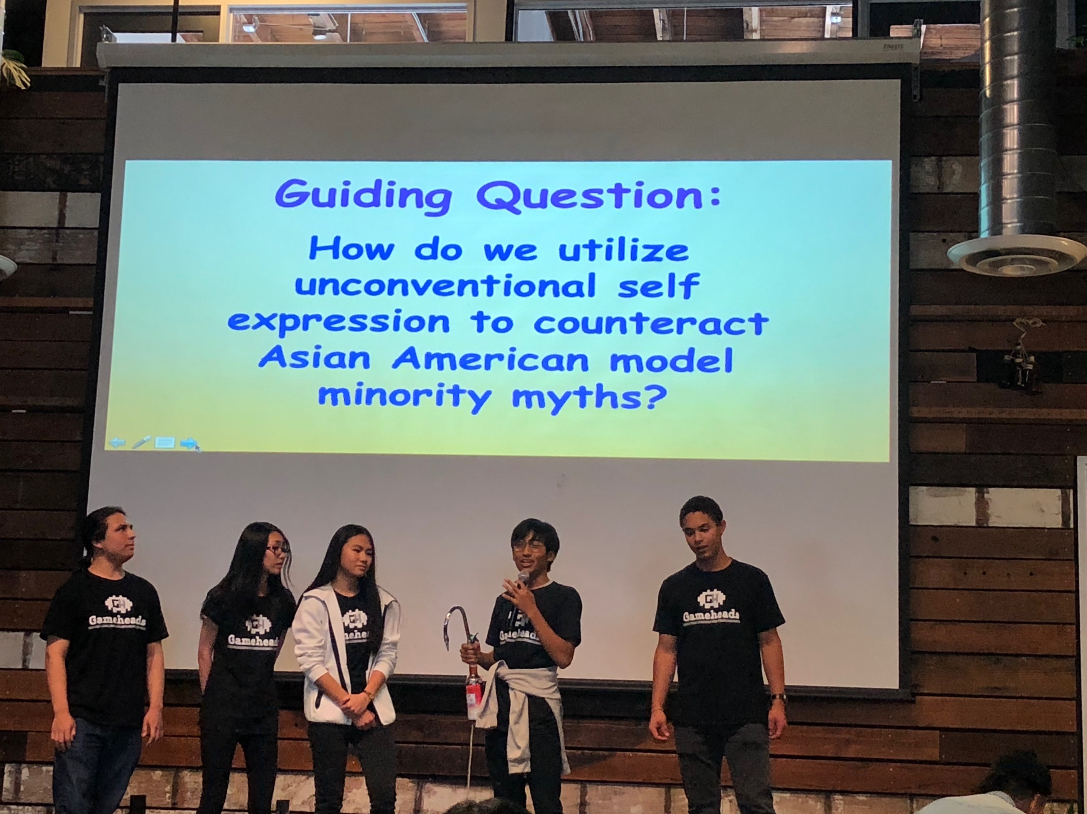 The students behind Offbeat describe the guiding question of their video game. Photo Credit: Tina Nazerian