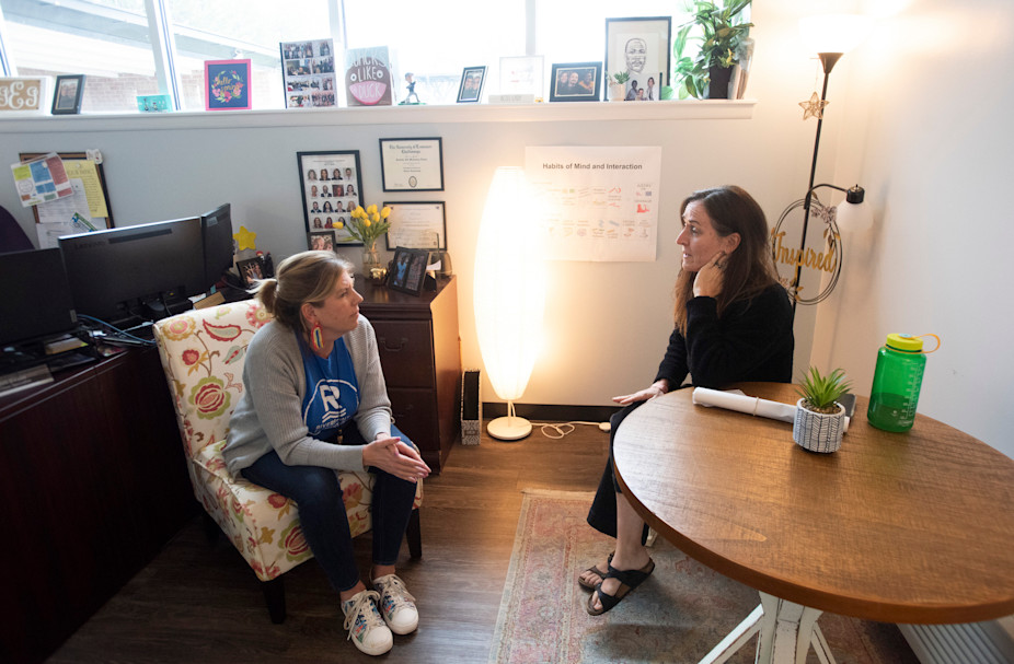 Evans, left, and educator Jennifer Knowles, right, discuss the Rivermont mindfulness program.