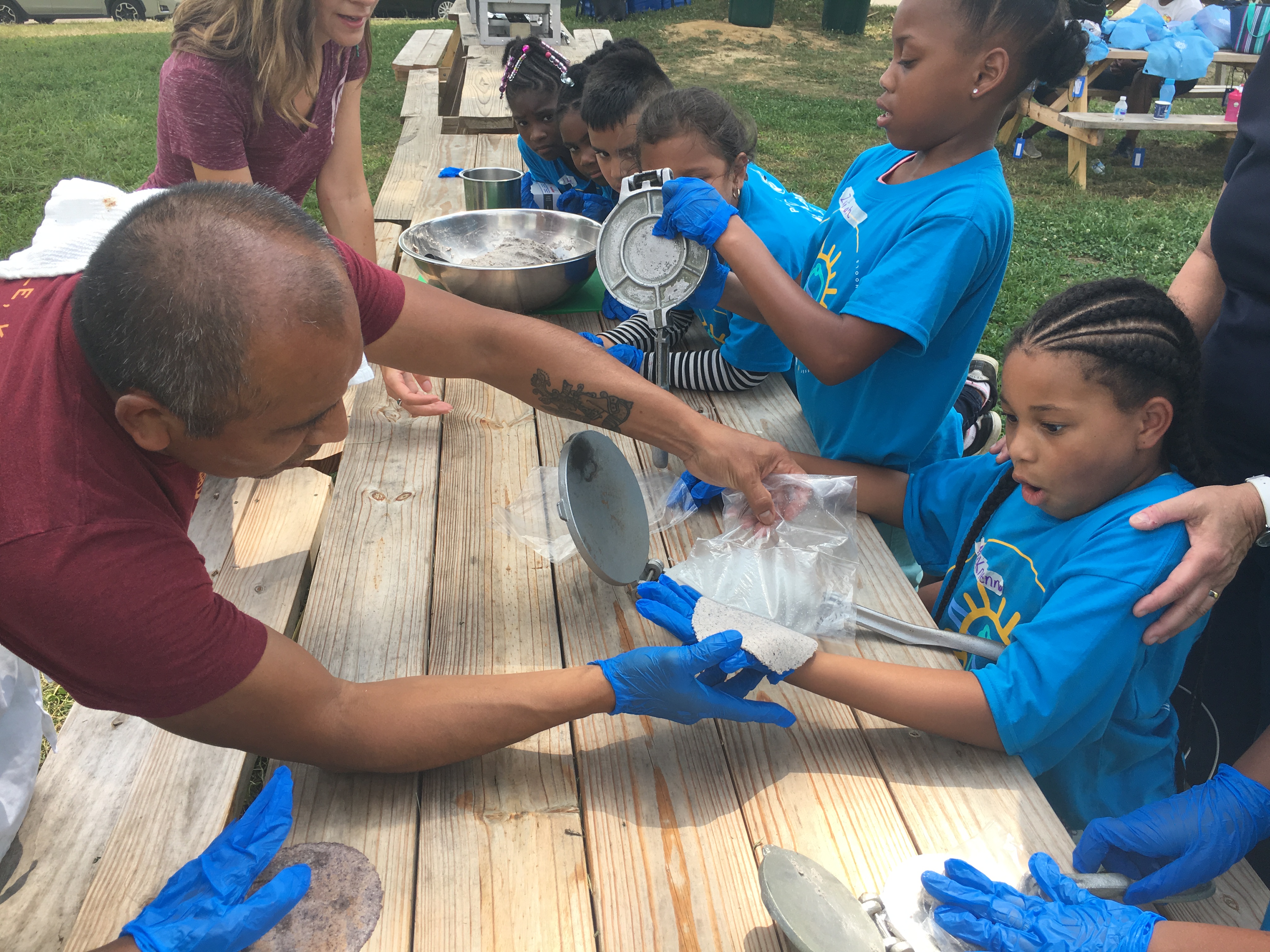 Students make tortillas with the help of a Mayan chef as part of the Backpack League summer program. (Image: JCPS)