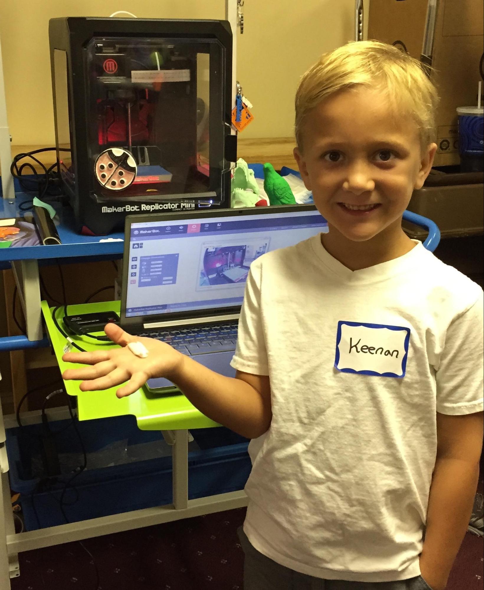 A TechTerra camper shows off the insect he created using the 3D Makerbot printer