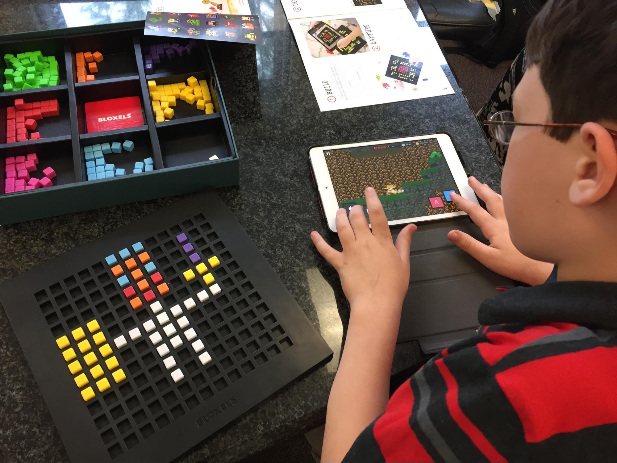 Student designing his own video game with Bloxels
