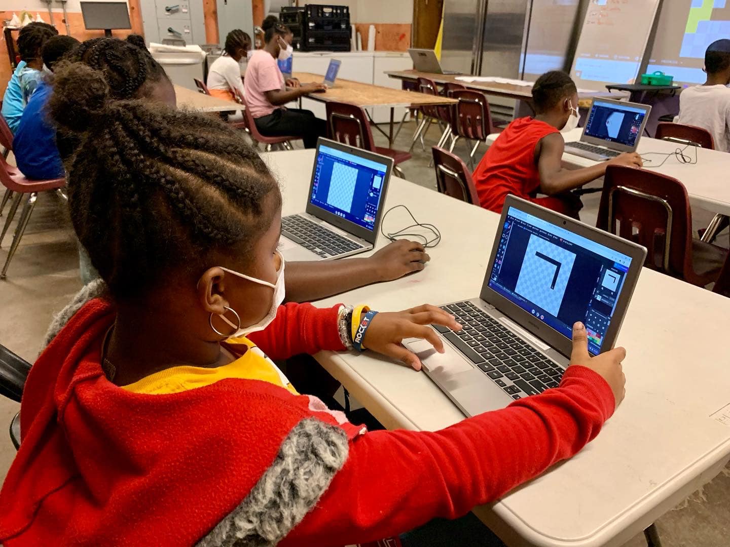 Children take a coding class. Photo courtesy of the Downtown Boxing Gym.