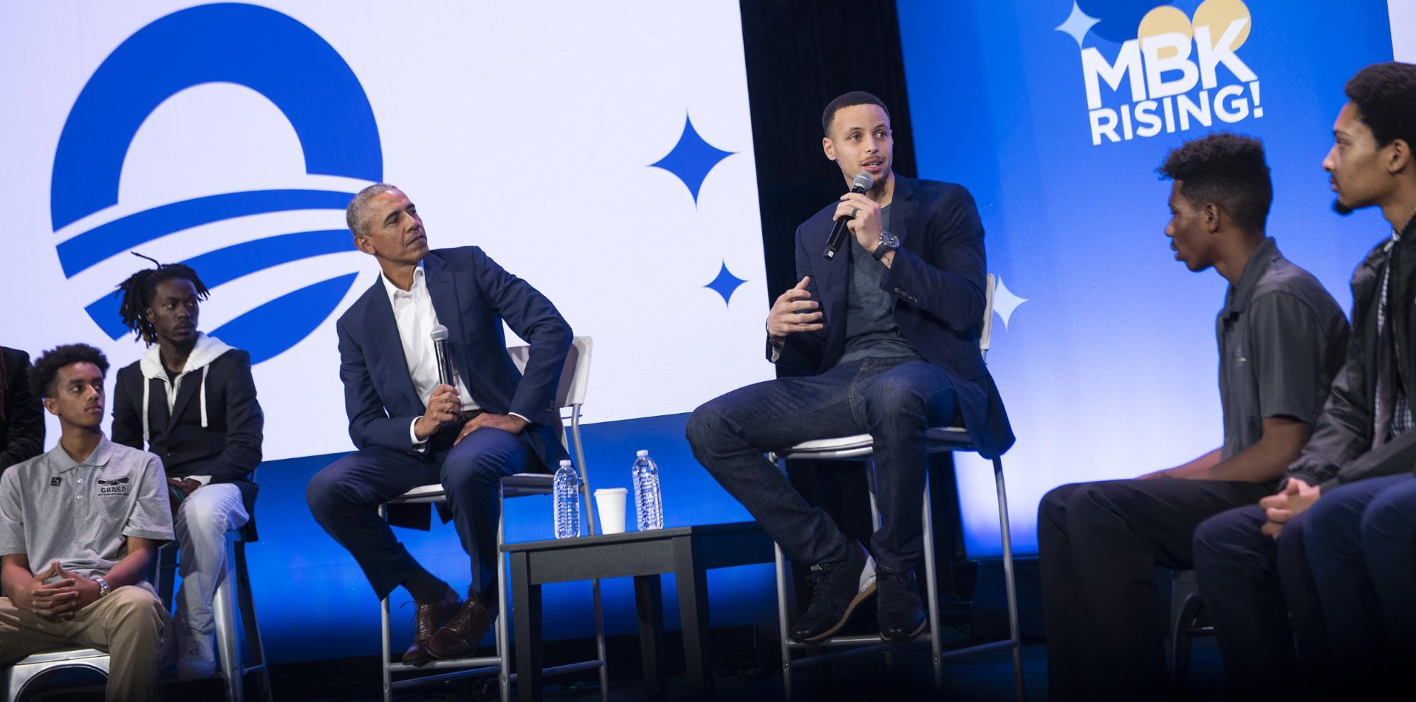 Obama and Golden State Warriors player Stephen Curry in conversation with members of MBK chapters from across the country. (Photo credit: Obama Foundation)