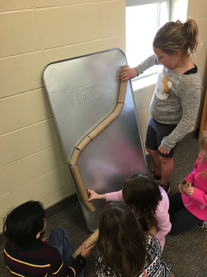 Students create a marble run with paper towels and magnets. (Harrisburg)