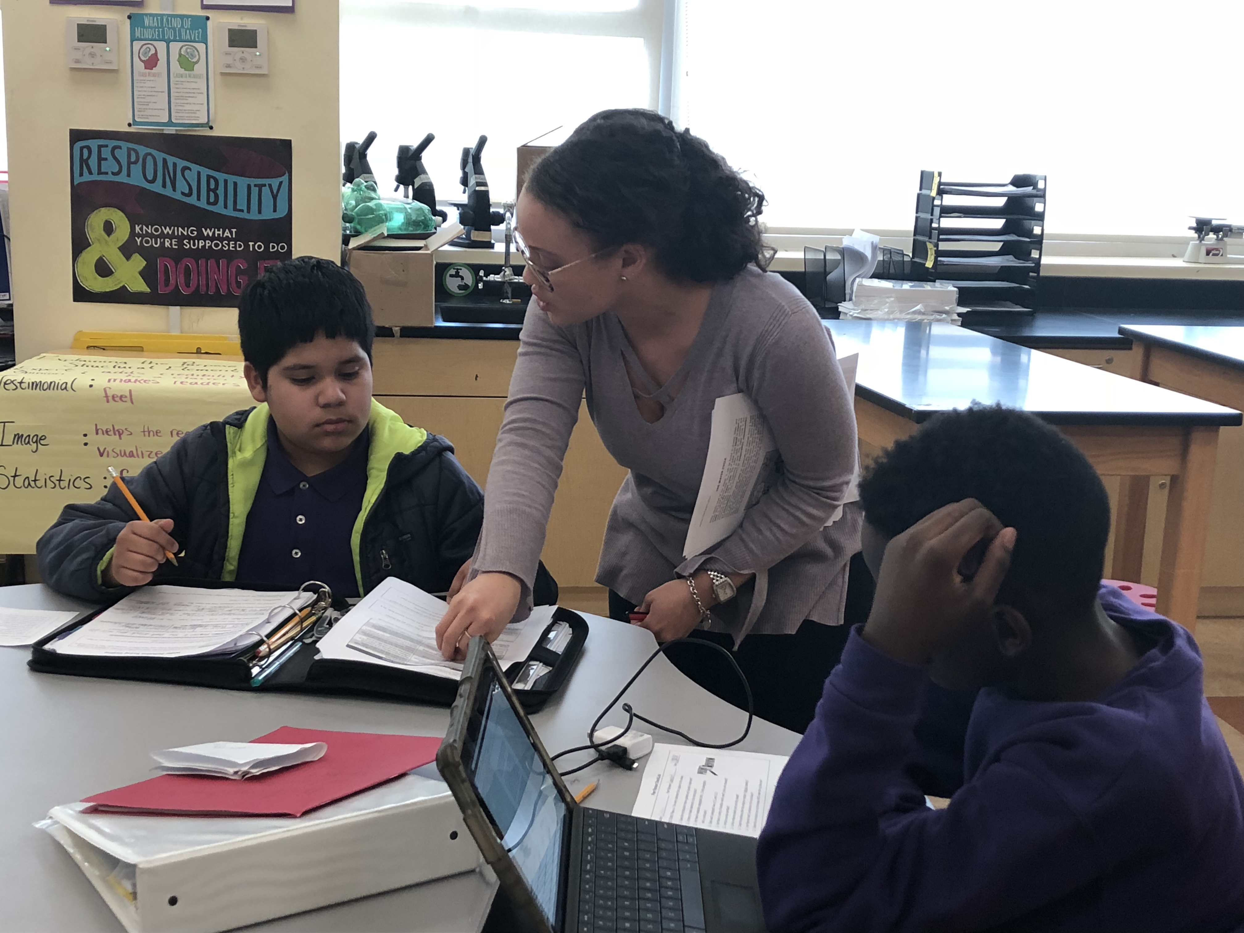 Teacher, Courtney Grant, walking around the science classroom helping students at Truesdell Education Campus Photo Credit: Jenny Abamu