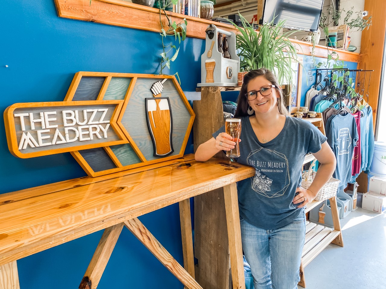 Megan Hines holds a glass of honey wine at Buzz Meadery, which she owns with her husband, a fellow teacher. (Photo courtesy of Hines)