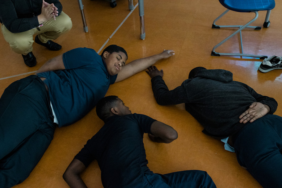 Students relax on the floor as part of a mindfulness exercise led by Cruz.