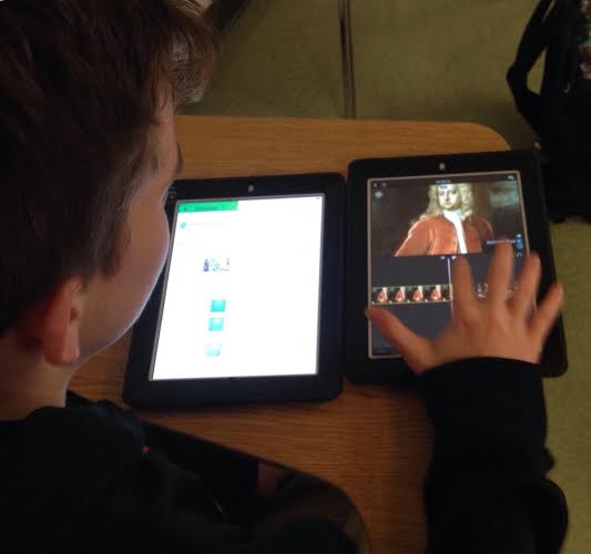 Student editing in iMovie while referencing the script he drafted in Evernote.