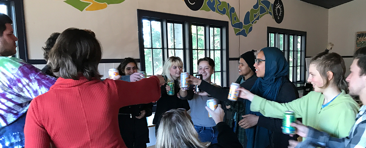 Wayfinding Academy students celebrate accomplishments from the semester during a recent meeting with an advisor.