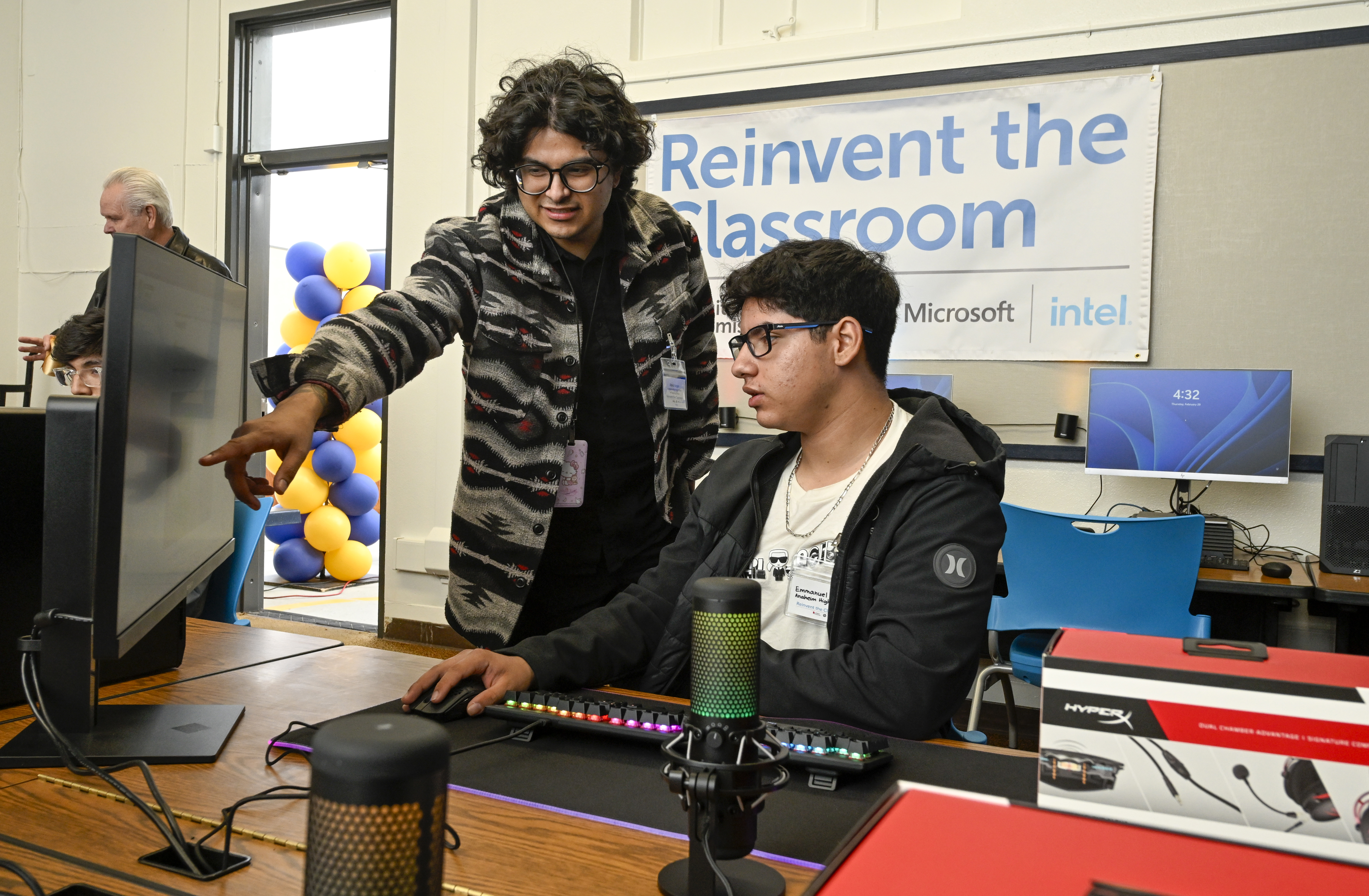 Educator Lex Vargas working with a student at HP Spotlight School Anaheim High School