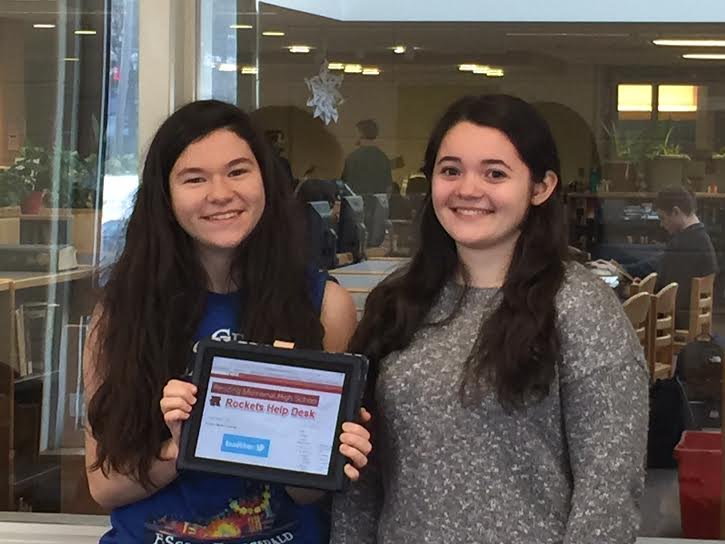 Julia Donohue (L) and Megan Catalano (R) stand outside of their student-run Help Desk.