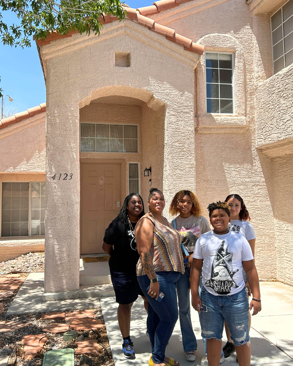 Destinee Hodges, second from left, with her two kids and close family friends outside her new house. Photo courtesy of Mission Driven Finance.