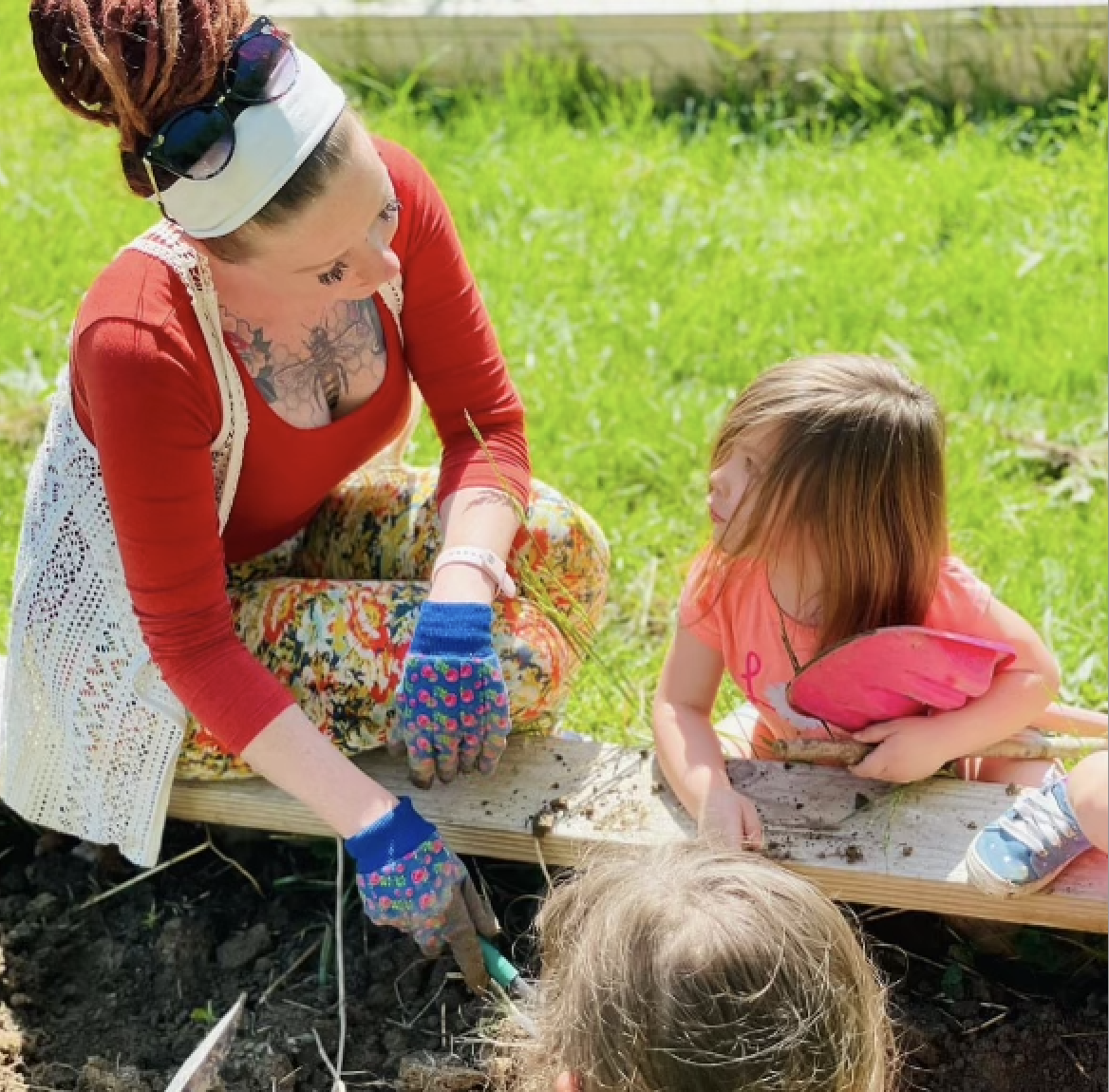 Gale and children working at a raised garden bed. Photo courtesy of Tiffany Gale.
