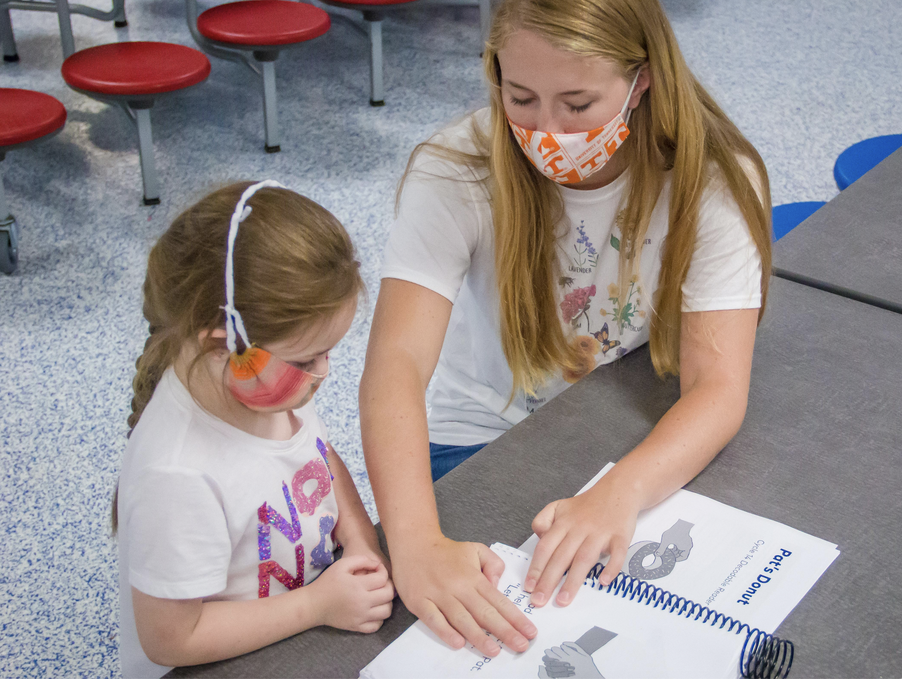 Savannah, 7, works on her reading skills with Tennessee Tutoring Corps member Julia at the Boys & Girls Club of Maury County. (Credit: Michelle Lamont)