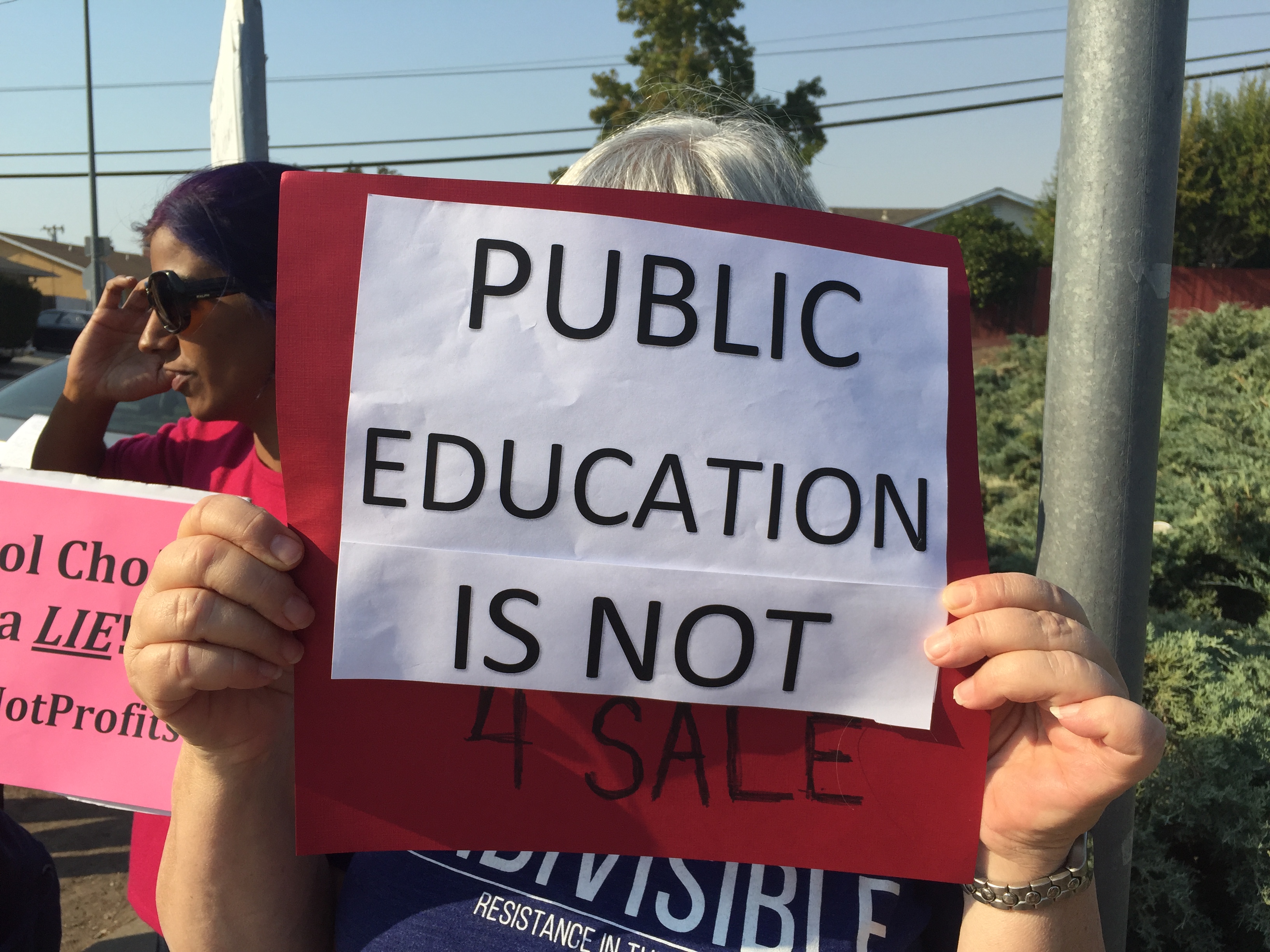 A protester holds her sign. Photo Credit: Tina Nazerian