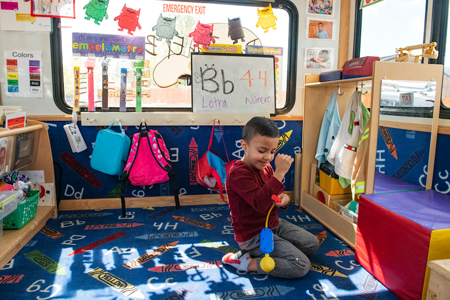During free play, Francisco Zelaya, 4, pulls out different learning tools found on El Busesito. Photo by Kelsey Brunner for EdSurge.