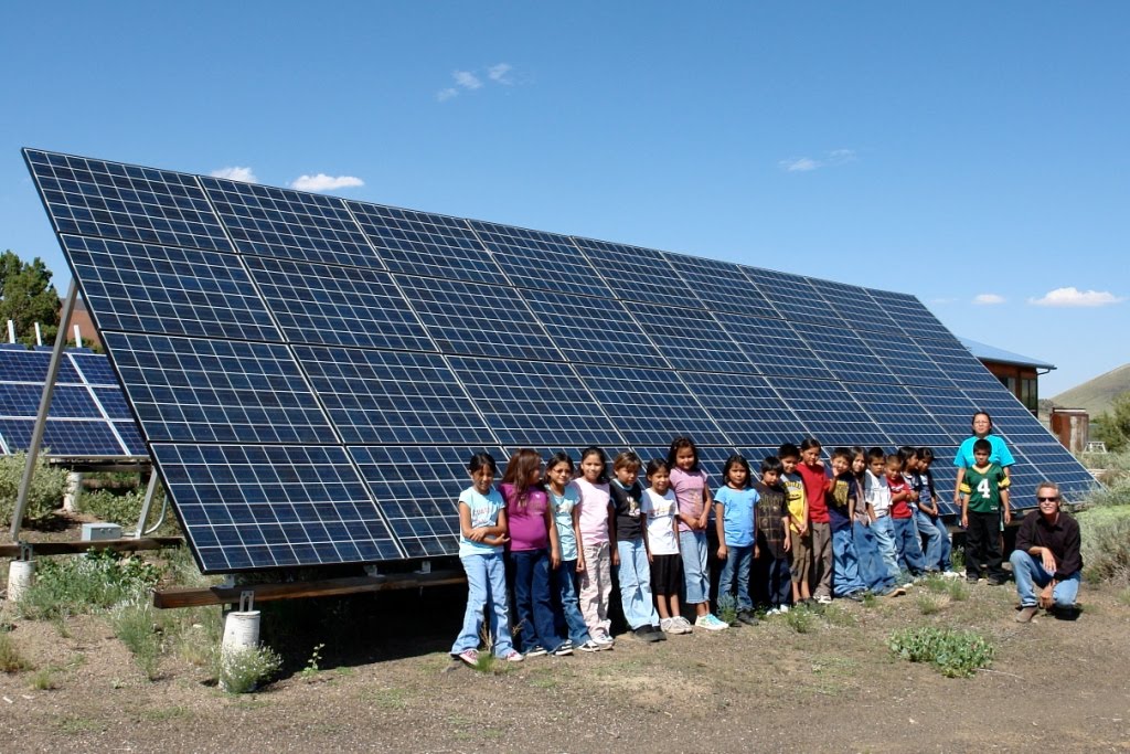 STAR students in front of solar panels which provide the school electricity