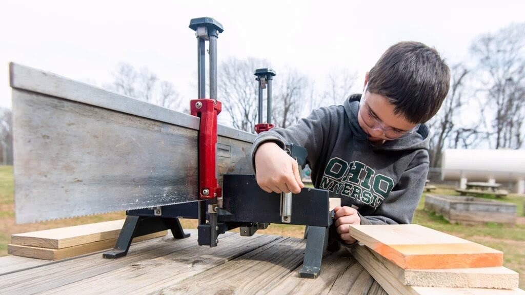 A student using a wood cutter.