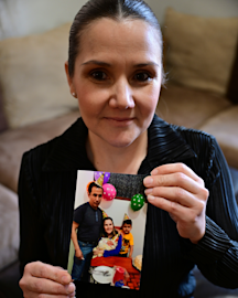 Valencia holds a photo of her family in her home in Pueblo, Colorado. Photo by Eric Lars Bakke for AP.